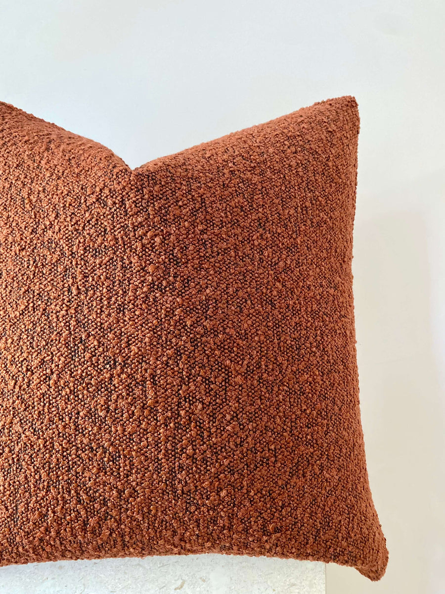 rust boucle cushion
