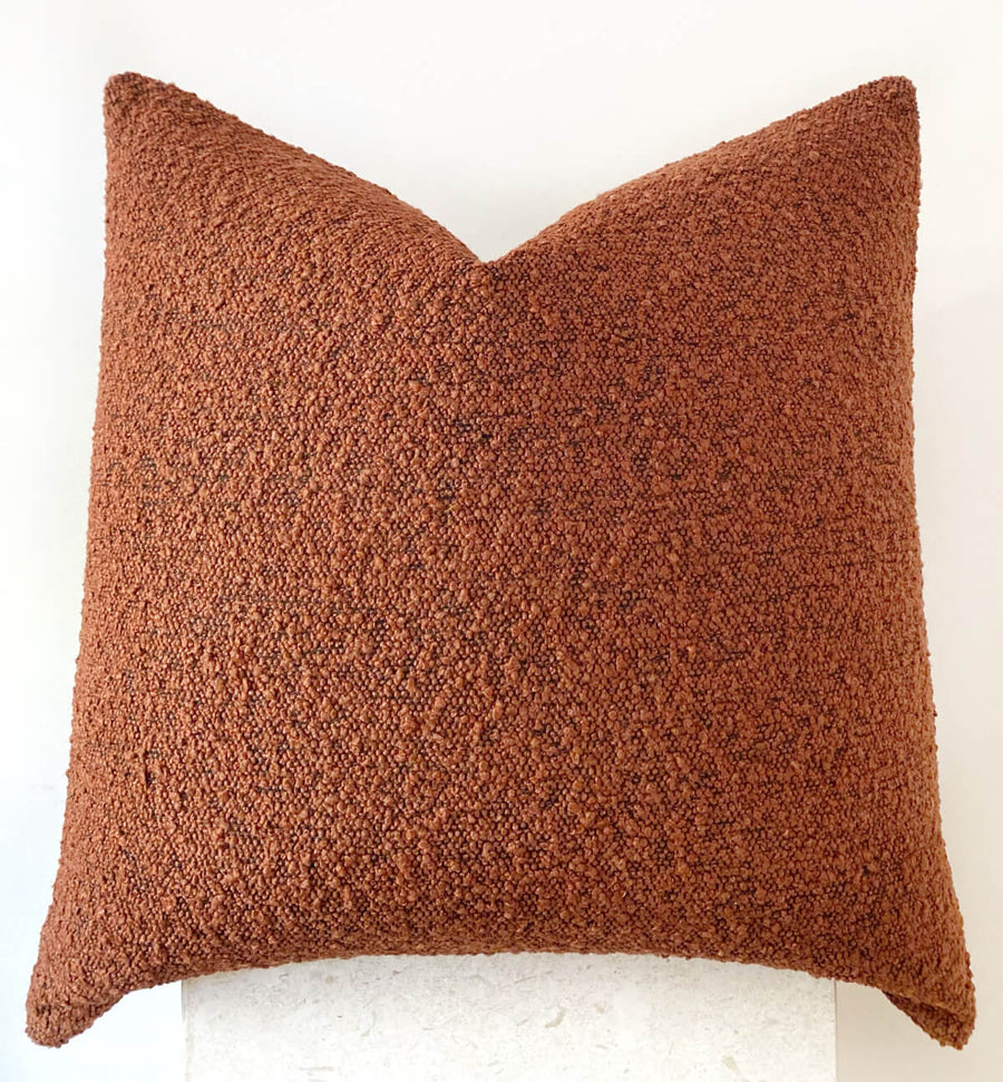 rust boucle cushion