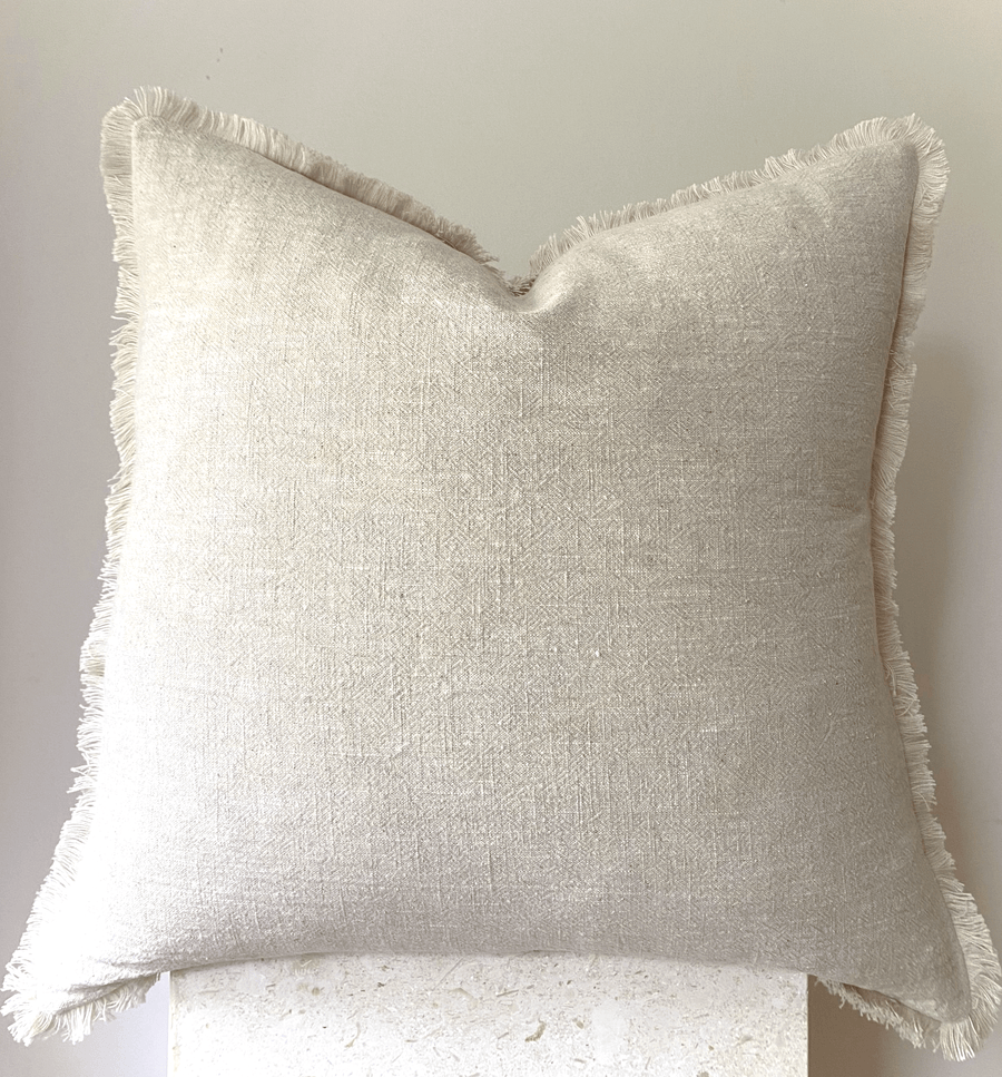 Cream fringed cotton cushion